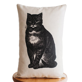 Vintage black cat lumbar throw pillow with distressed illustration on a neutral background