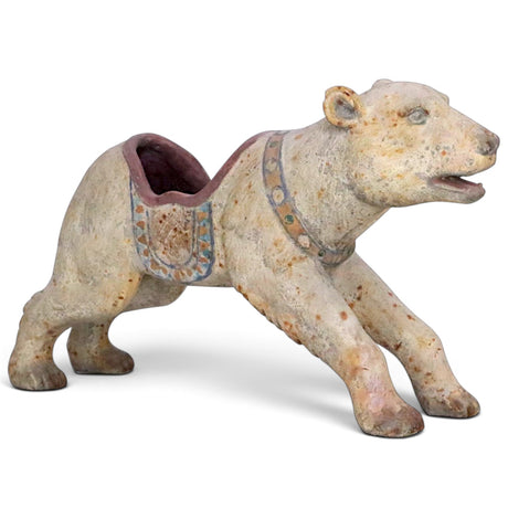 Distressed cream carousel polar bear container with a muted multicolor saddle, decorative collar, and an opening in its back.