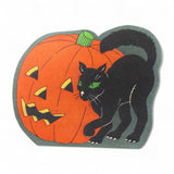 Vintage-inspired Halloween sign with black cat and pumpkin on display with treats