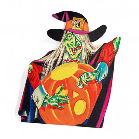 Vintage-style metal Halloween dummy board with wicked witch holding a pumpkin