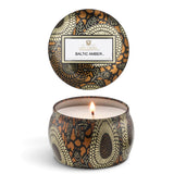 Voluspa Baltic Amber 4 oz Mini Tin Candle with decorative black, gold, and amber floral design