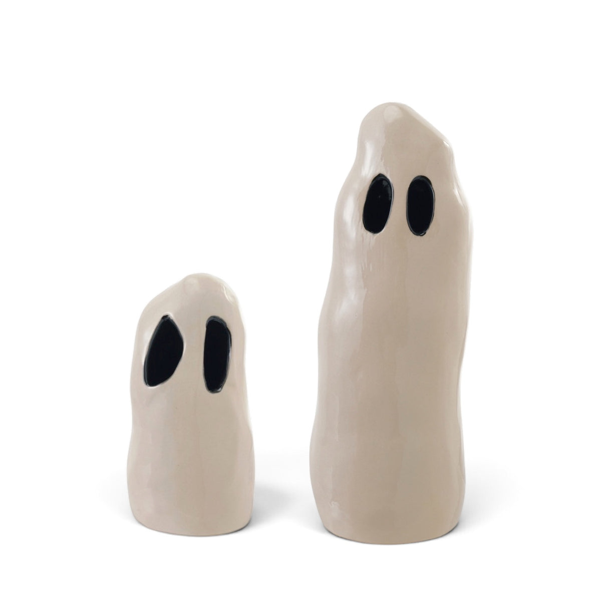 White ceramic Halloween ghosts with black cutout eyes in small and large sizes
