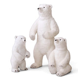 Three white faux fur polar bear decorations in small, medium, and large sizes, with dark facial details and standing or seated poses