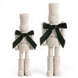 White resin wicker nutcrackers with green velvet bows in two sizes
