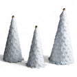 White velvet holiday trees with ribbon loops and gold jingle bell toppers, available in three sizes