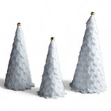 White velvet holiday trees with ribbon loops and gold jingle bell toppers, available in three sizes