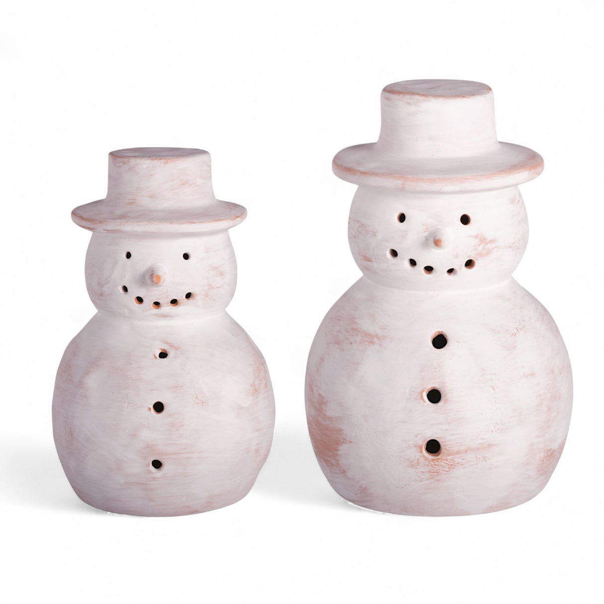 White-washed terracotta snowman luminaries in two sizes with pierced holes for flameless tea lights