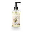 ILLUME Winter White hand soap in a clear 8 fl oz bottle with a black pump and cream botanical label with gold accents