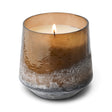 Woodfire candle in amber-brown Baltic glass with a textured silver-gray base, cream-colored wax, and a single wick
