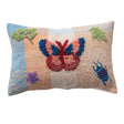 Woven lumbar pillow with tufted butterfly, insects, and floral embroidery